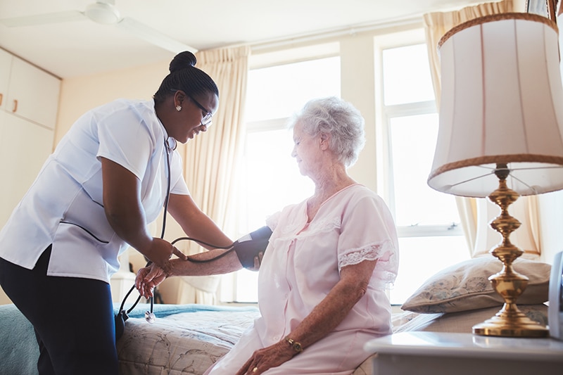 Nursing staff checking resident vitals, offering skilled nursing & health care in Lewisville, TX