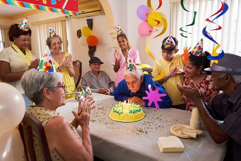 Group of seniors enjoying a birthday celebration and social activity in Lewisville, TX