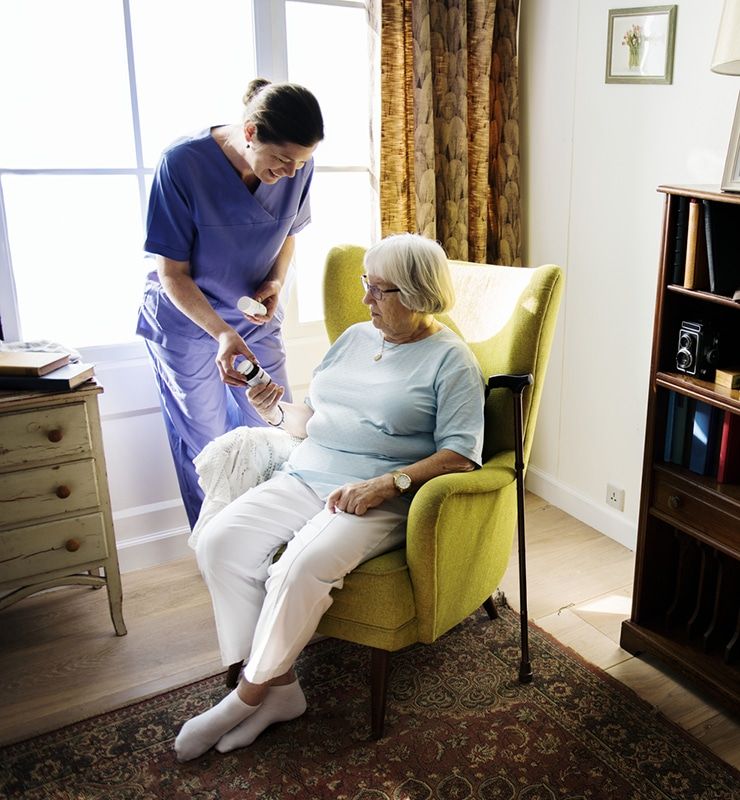 Caregiver assisting senior with daily support in a comfortable home setting in Lewisville, TX