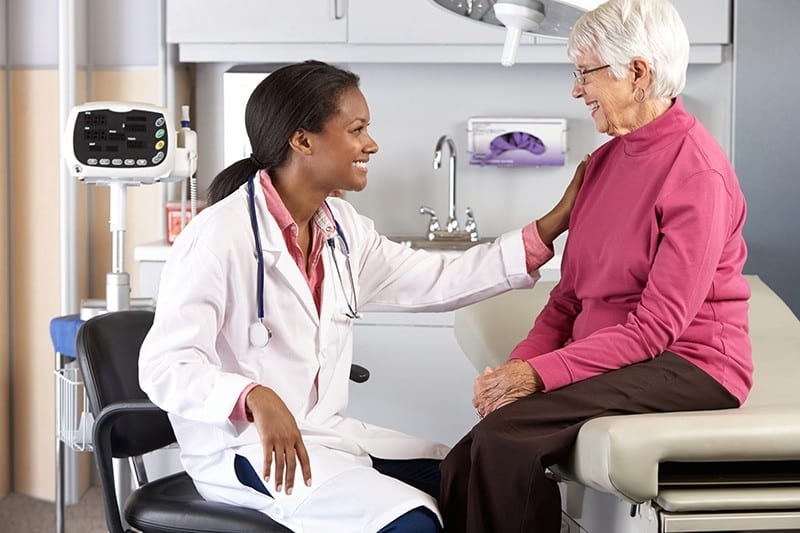 Doctor providing medical checkup and support to senior patient in Lewisville, TX