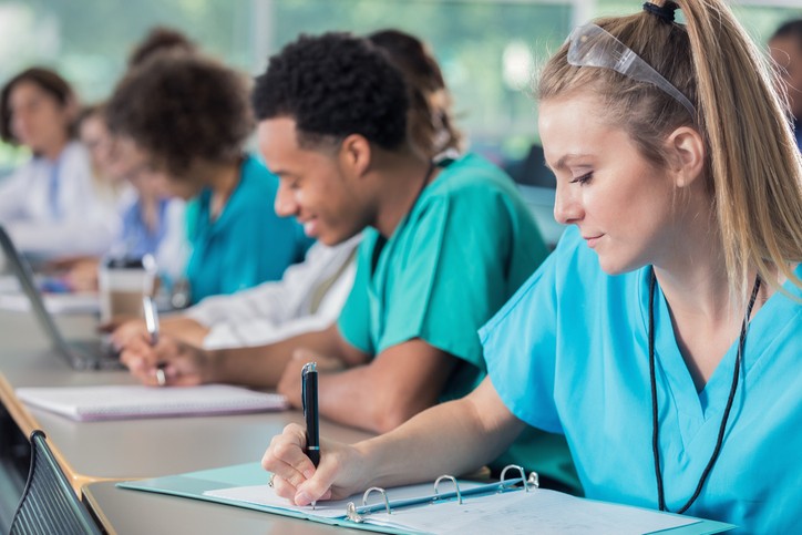 Nurses write in a patient's file with focused attention in Lewisville, TX